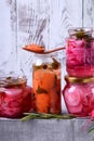 Chopped radish, carrot and red onion marinated in glass jars Royalty Free Stock Photo