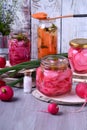 Chopped radish, carrot and red onion marinated in glass jars Royalty Free Stock Photo