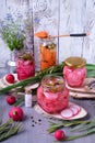 Chopped radish, carrot and red onion marinated in glass jars Royalty Free Stock Photo