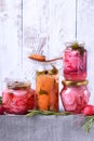 Chopped radish, carrot and red onion marinated in glass jars Royalty Free Stock Photo
