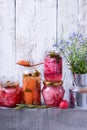 Chopped radish, carrot and red onion marinated in glass jars Royalty Free Stock Photo