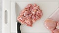 Chopped raw chicken fillet close-up on a white plastic cutting board Royalty Free Stock Photo