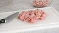 Chopped raw chicken fillet close-up on a white plastic cutting board Royalty Free Stock Photo