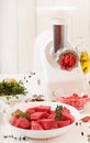 Chopped raw meat. The process of preparing forcemeat by means of a meat grinder