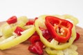 Chopped red and green peppers on the kitchen wooden board Royalty Free Stock Photo