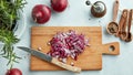 Chopped red onions on wooden cutting board Royalty Free Stock Photo