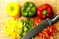 Chopped red and yellow green peppers with cutting knife on wood. gastronomy concept Flat lay Royalty Free Stock Photo