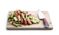 Chopped rhubarb stalks on wooden board isolated on white