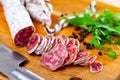 Chopped sausage fuet on wooden cutting board Royalty Free Stock Photo