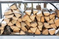 Chopped stock of firewood under snow on the street. Firewood for fireplace and bbq Royalty Free Stock Photo
