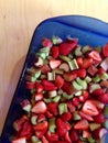 Chopped strawberry and rhubarb in a blue baking dish