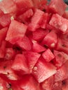 Chopped watermelon fruit cubes. Vertical close up
