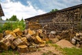 Chopped wood is stacked in a woodpile, preparing firewood for the winter