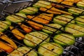 Chopped zucchini and carrots roasting on fire seasoned with aroma herbs and spices. Delicious fresh vegetables grilling Royalty Free Stock Photo