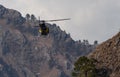 A Chopper flying from between mountain valley in rescue operation concept Royalty Free Stock Photo