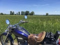 Chopper motorcycle standing at the roadside, a meadow in background Royalty Free Stock Photo