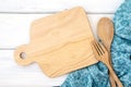 a chopping board and tablecloth with wooden fork and spoon on white table , recipes food  for healthy habits shot note background Royalty Free Stock Photo