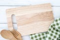 A chopping board and a tablecloth with wooden fork and spoon on white table , recipes food  for healthy habits shot note Royalty Free Stock Photo