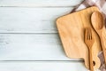 chopping board with wooden fork and spoon on white table , recipes food for healthy habits shot note background concept