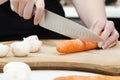 Chopping carrots on a chopping board Royalty Free Stock Photo