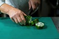 Chopping the fish wrapped in a roll with cling film. Royalty Free Stock Photo