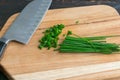 Chopping Fresh Chives on a Wood Cutting Board Royalty Free Stock Photo