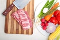 Chopping fresh pork ribs and vegetables Royalty Free Stock Photo