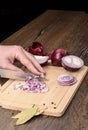 Chopping red onions on a cutting board Royalty Free Stock Photo