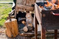 Chopping wood for barbeque party. Grill with fire and a cat waiting for food Royalty Free Stock Photo