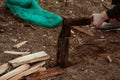 Chopping wood for the fire with an axe. A man& x27;s hand with an axe chopping wood, close-up. Preparing for the barbecue Royalty Free Stock Photo