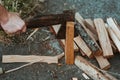 Chopping wood for the fire with an axe. A man& x27;s hand with an axe chopping wood, close-up. Preparing for the barbecue Royalty Free Stock Photo