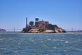 Choppy San Francisco Bay waters with close view of Alcatraz Island and distant Golden Gate Bridge