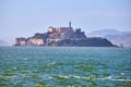 Choppy San Francisco Bay waters with full view of Alcatraz Island and docked boat