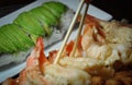 Chopstick getting shrimp tempura in the table Royalty Free Stock Photo