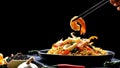 Chopstick pickup shrimp with stir fry instant noodles spicy