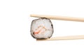 Chopstick with sushi roll closeup