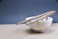 Chopsticks with bowl on grey background