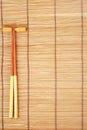 Chopsticks on brown bamboo matting background