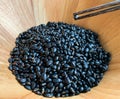 Chopsticks cubed black beans in a wooden bowl, properties help to detoxify and nourish the kidneys well. Due to the presence of Royalty Free Stock Photo