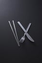 Chopsticks, fork and knife. Conceptual image Royalty Free Stock Photo