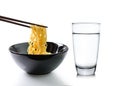 Chopsticks holding noodles and Glass of water on white Royalty Free Stock Photo