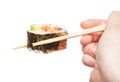 Chopsticks holds western-style sushi roll isolated Royalty Free Stock Photo