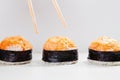 Chopsticks Reaching for Baked Salmon Gunkan Sushi