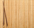 Chopsticks on straw mat Royalty Free Stock Photo