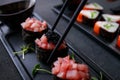 Chopsticks taking tuna gunkan maki roll from plate Royalty Free Stock Photo
