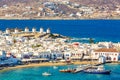 Chora port of Mykonos island with red church, famous windmills, ships and yachts during summer sunny day. Aegean sea, Greece Royalty Free Stock Photo