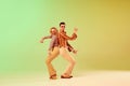 Choreography. Two talented people, autistic man and woman in vintage clothes dancing against gradient green yellow