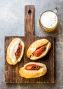 Choripan. Latin American Argentine and chilean food. Grilled chorizo sausages hot dogs served with beer, top view, stone Royalty Free Stock Photo