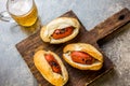 Choripan. Latin American Argentine and chilean food. Grilled chorizo sausages hot dogs served with beer, top view, stone Royalty Free Stock Photo