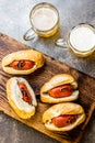 Choripan. Latin American Argentine and chilean food. Grilled chorizo sausages hot dogs served with beer, top view, stone Royalty Free Stock Photo